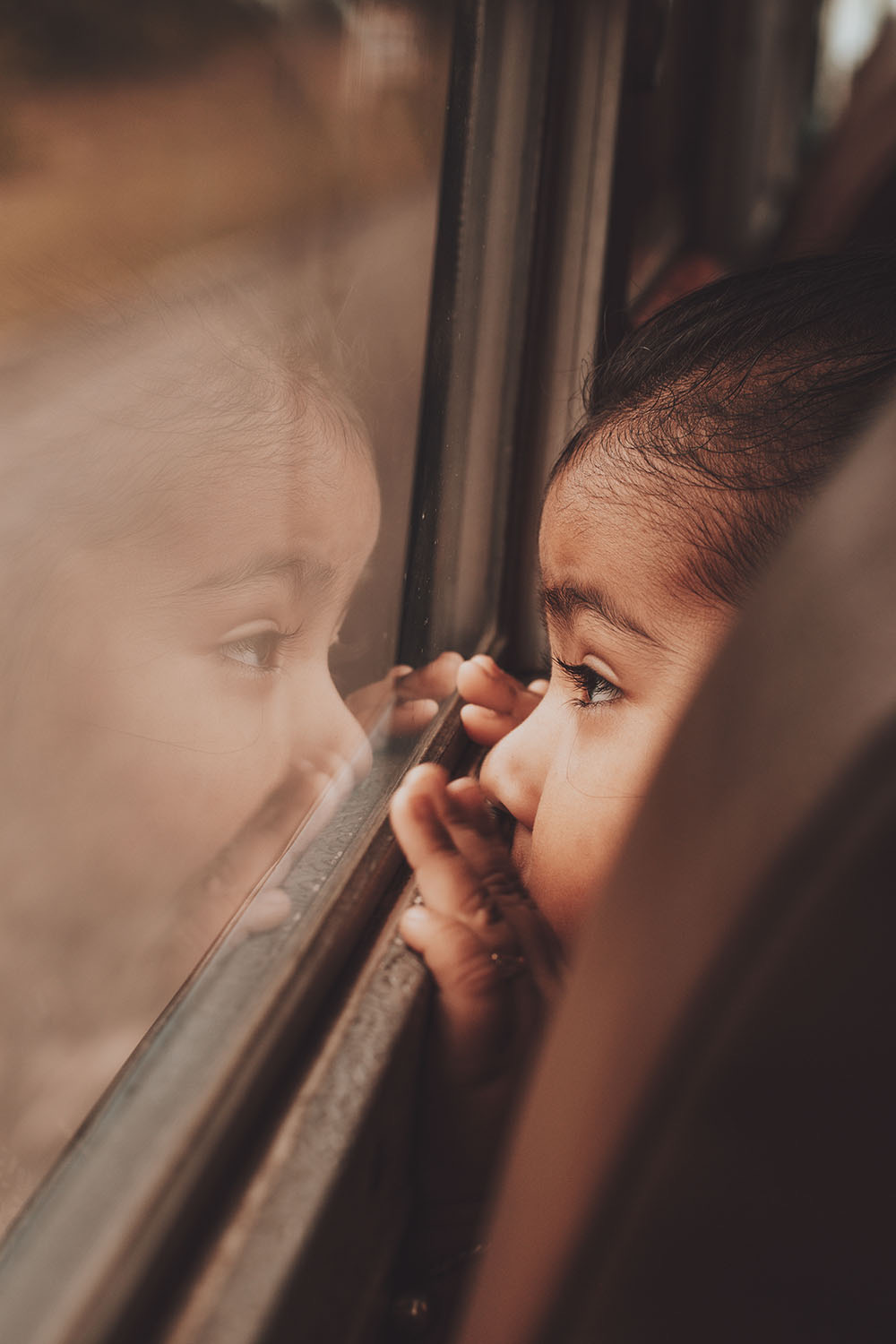 Girl looking out of a train window