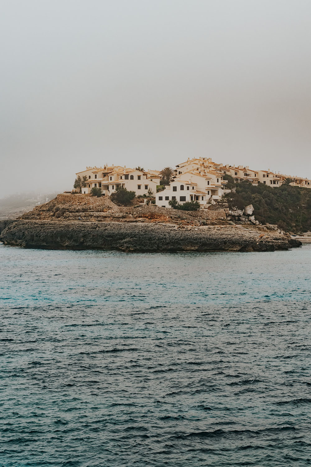 Small island with houses in a calm sea